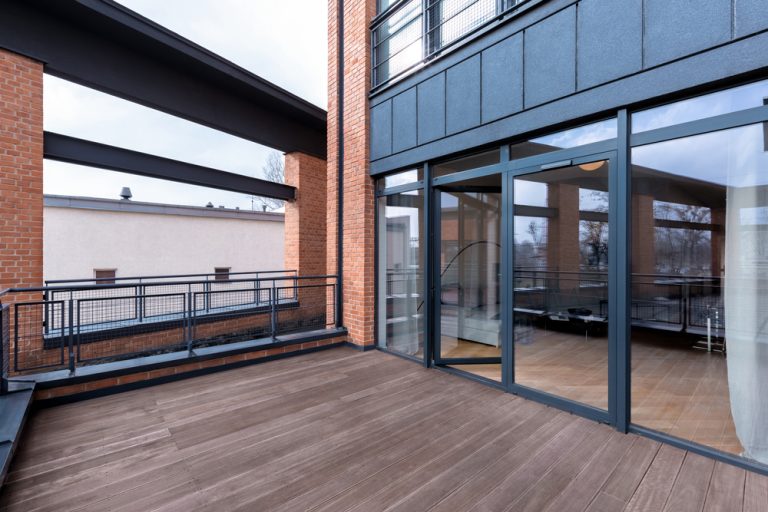 Stylish,Terrace,With,Wooden,Floor,And,Fancy,Balustrade,In,Building